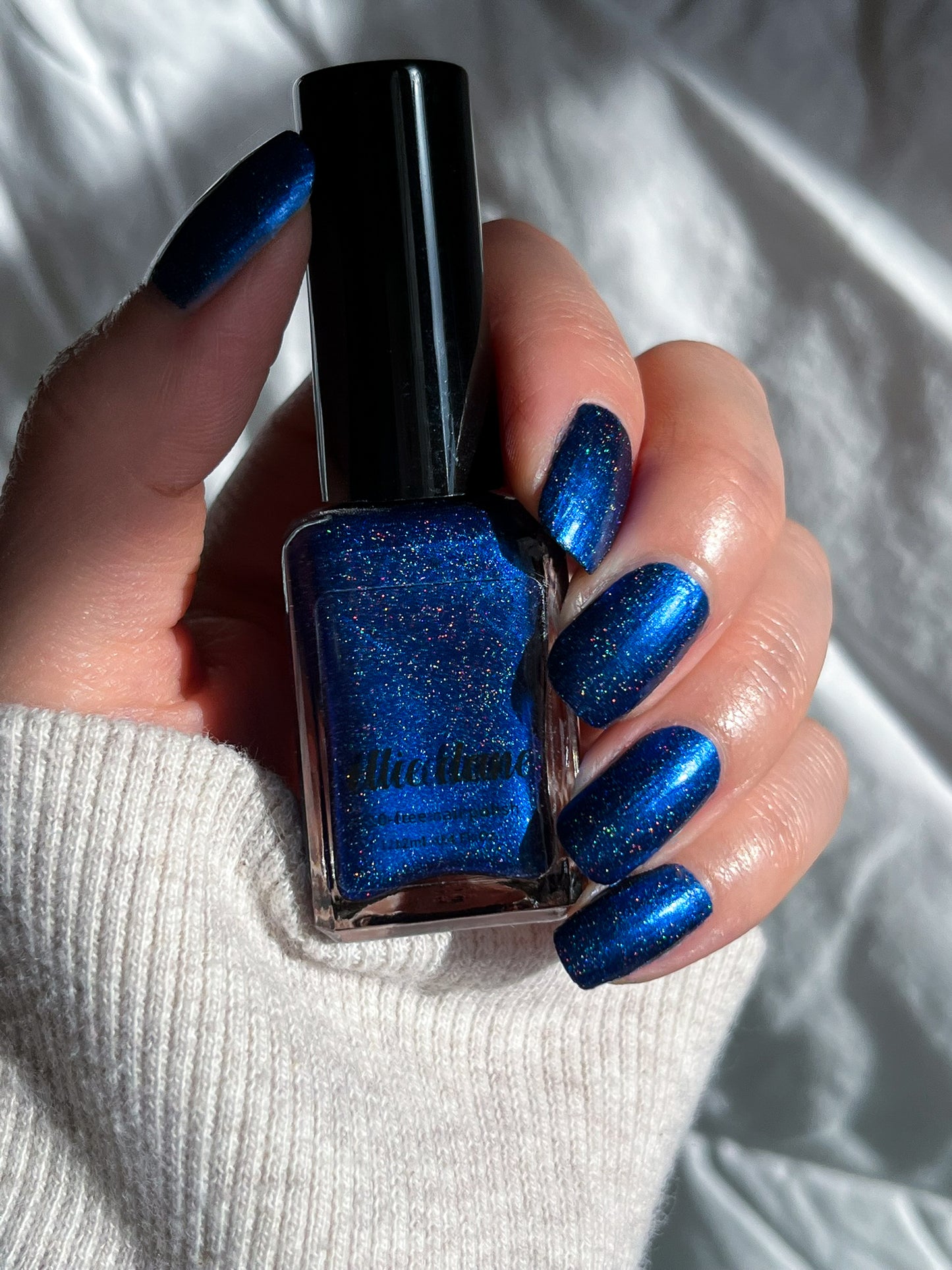 Ocean of Memories royal blue holographic navy nail polish swatch on nails