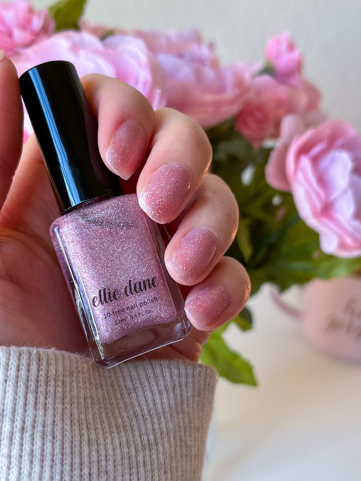 Hand swatch of Rose Quartz pink nail polish on nails