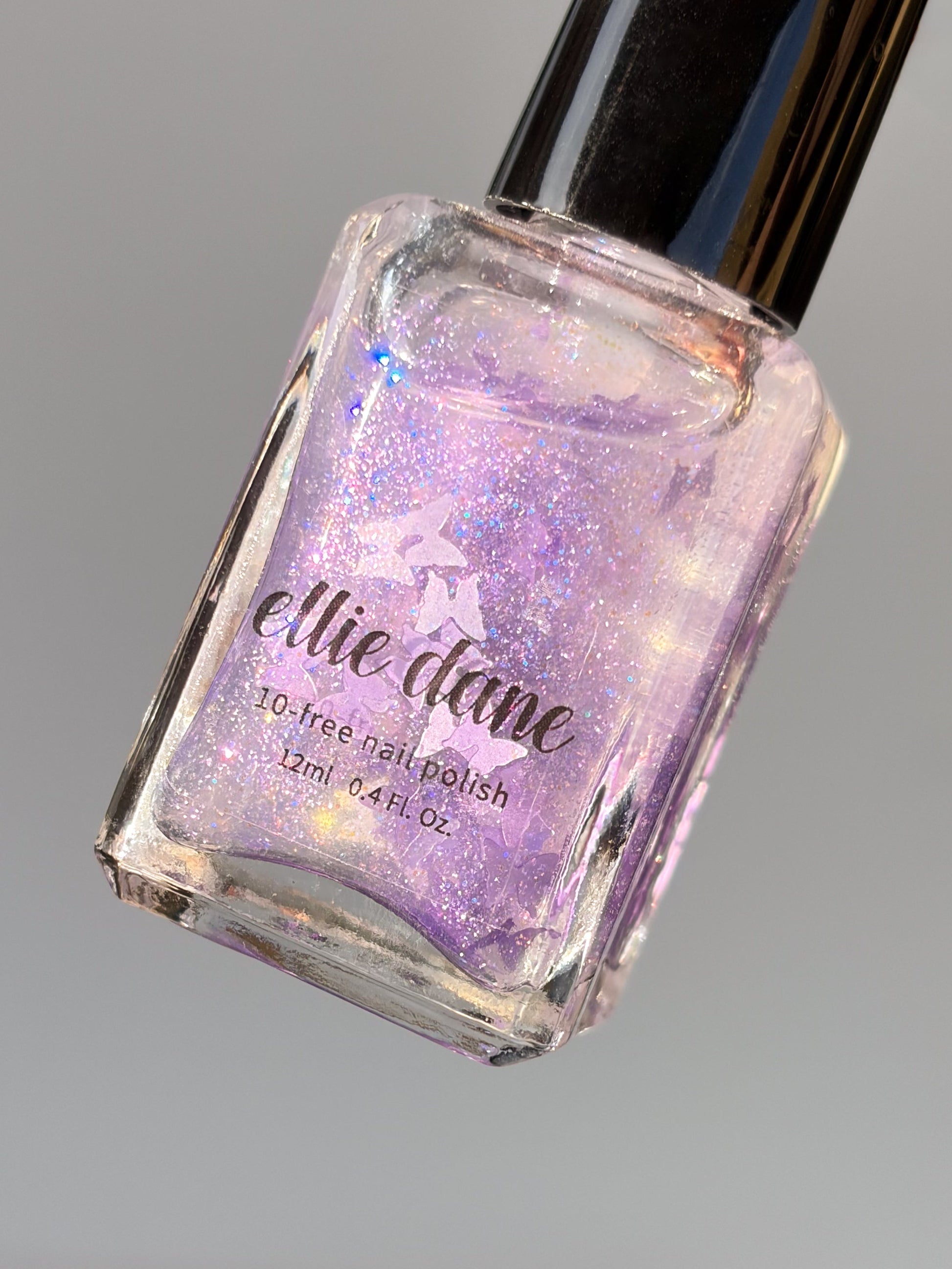 Purple glitter butterfly nail polish bottle with 'ellie dane' branding