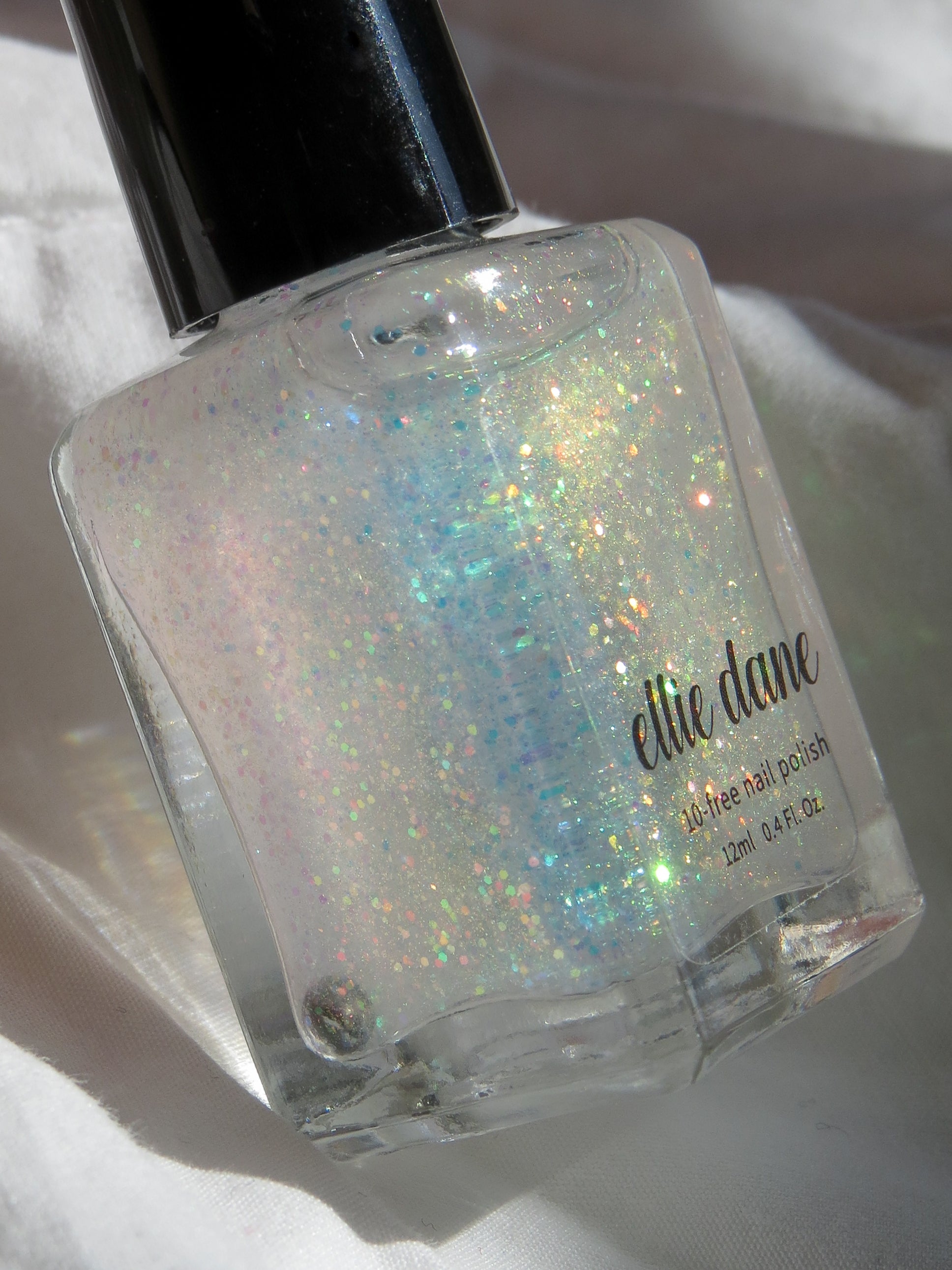 Nail polish bottle with glittery polish on a white background