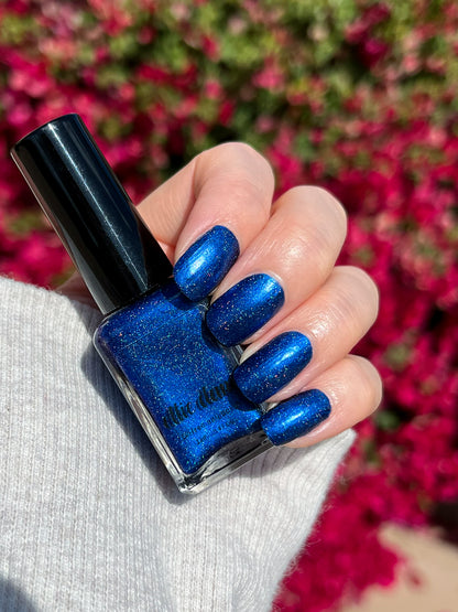 Ocean of Memories holographic blue nail polish swatched on nails with bottle